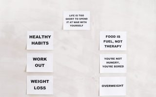 Minimalist display of motivational health and wellness quotes emphasizing healthy habits and weight management.